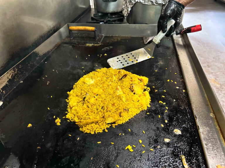 Person cooking rice and meat