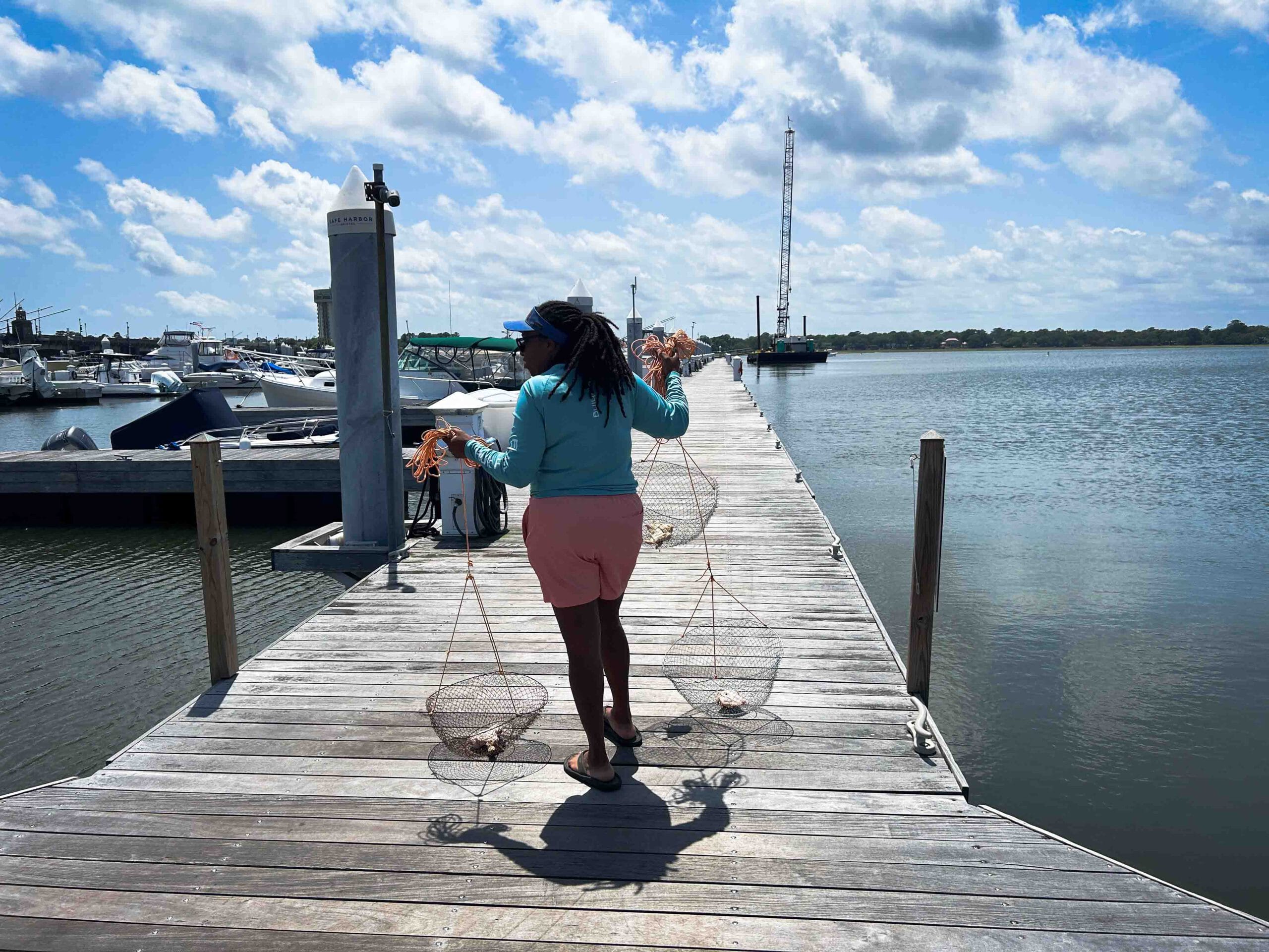 Lady holding crap traps on dock