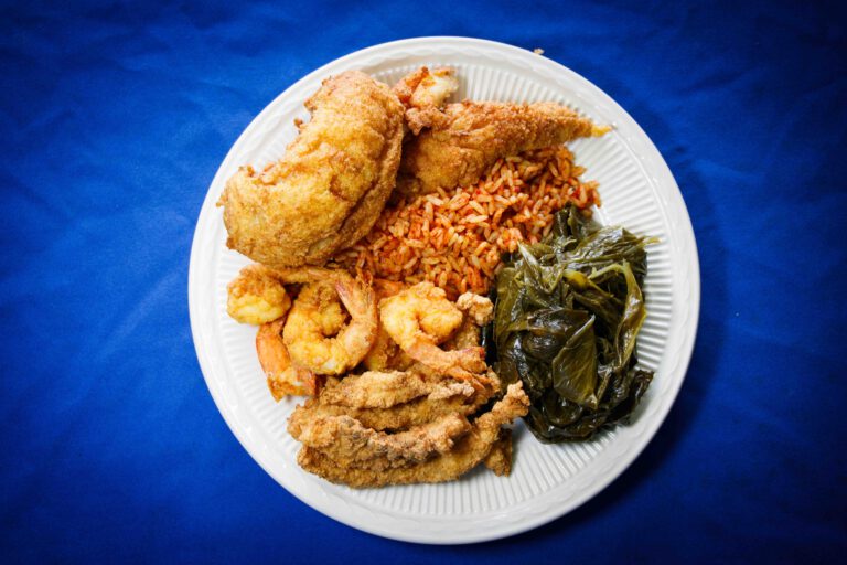 Picture of a plate with fish, chicken, shrimp, and collar greens from Gullah Grab Restaurant St. Helena Island, SC